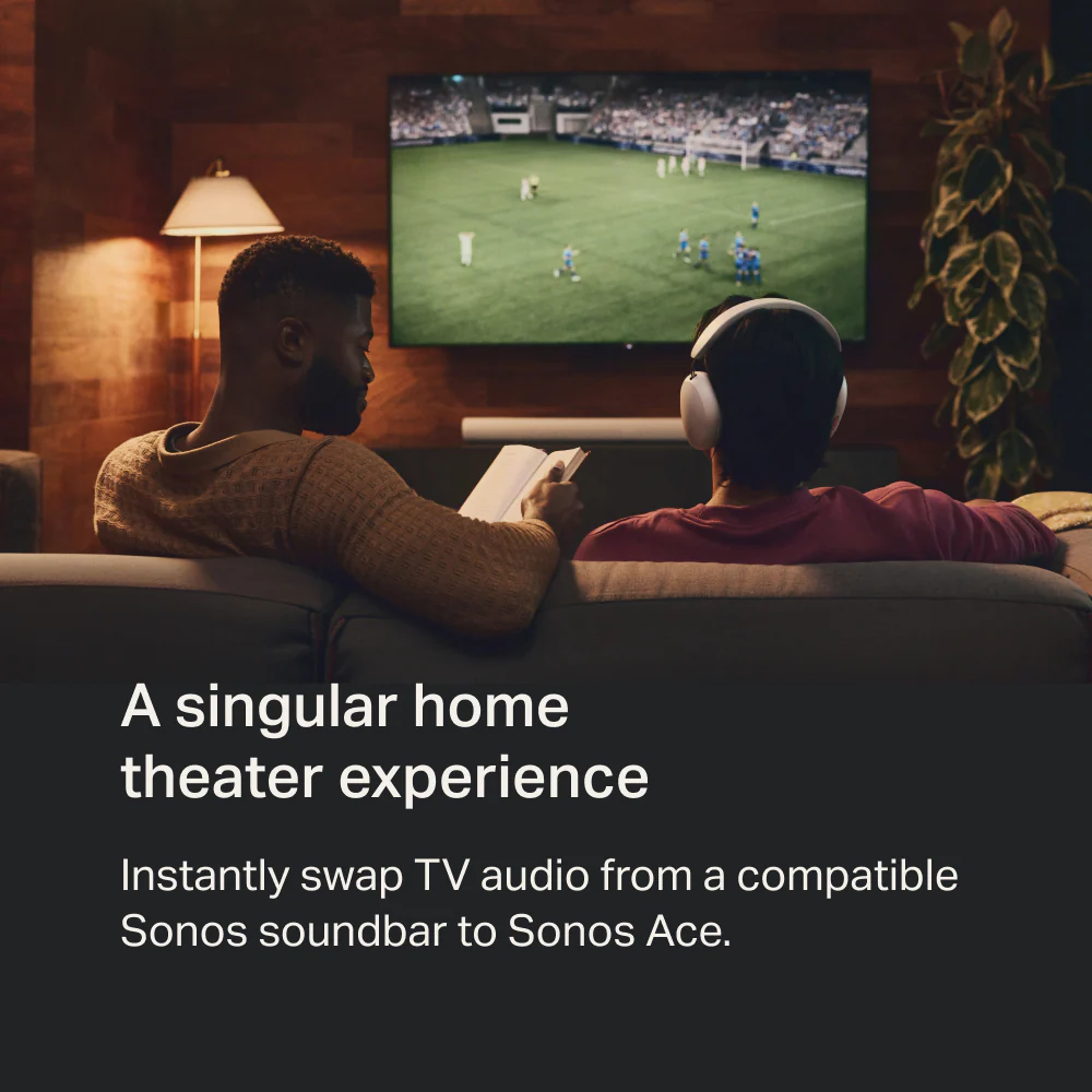 Two men sitting on a couch, one reading a book and the other wearing Sonos Ace headphones listening to a TV. The text 